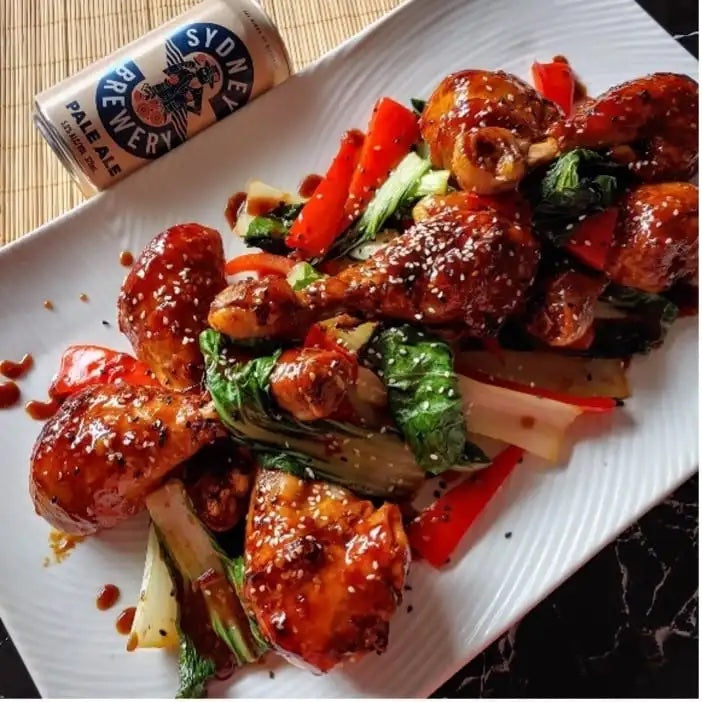 STICKY SPICED PALE ALE CHICKEN DRUMSTICKS WITH ASIAN GREENS